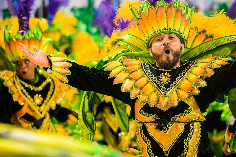 Cheerful guy parading in a samba school costume