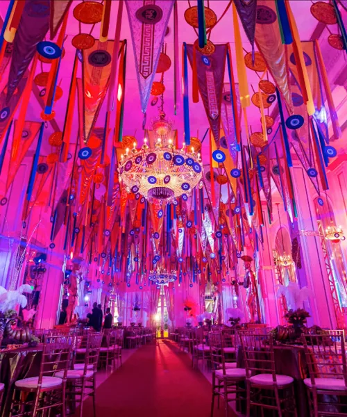 Guests in black tie at a candlelit gala dinner table in the Copacabana Palace ballroom during the Copa Ball